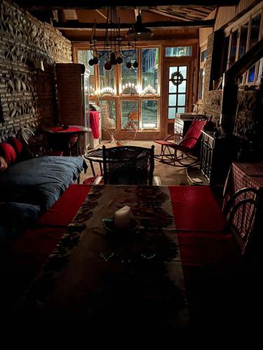 a living room with a couch and a table at Dzveli Galavani -Old Wall in Tʼelavi