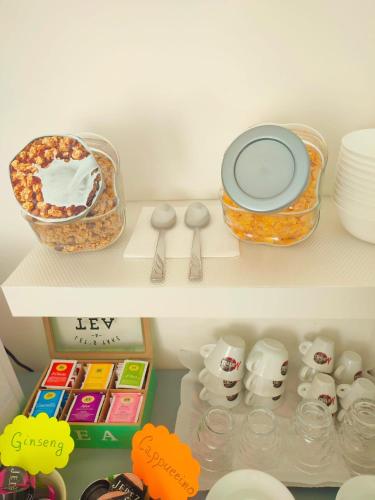 two shelves of a refrigerator filled with food and desserts at F.A.M. ROOMS in Ciampino