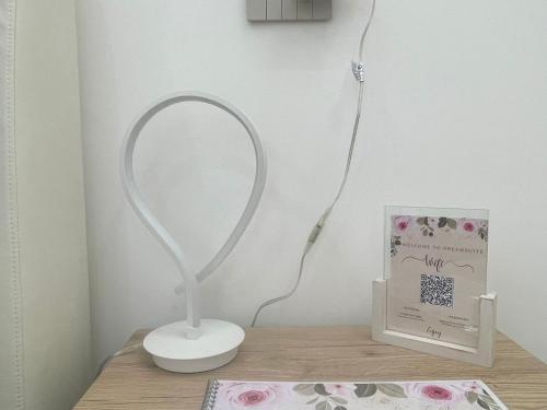 a white lamp sitting on a table next to a box at Dream Suite Bologna in Bologna