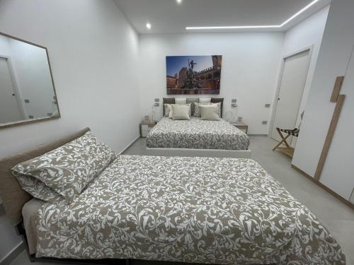 a bedroom with two beds and a couch at Dream Suite Bologna in Bologna