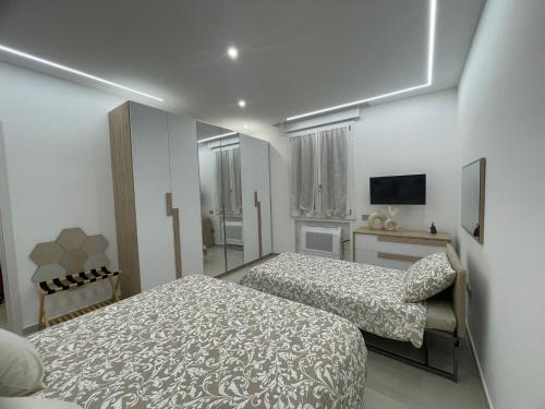 a hotel room with two beds and a television at Dream Suite Bologna in Bologna