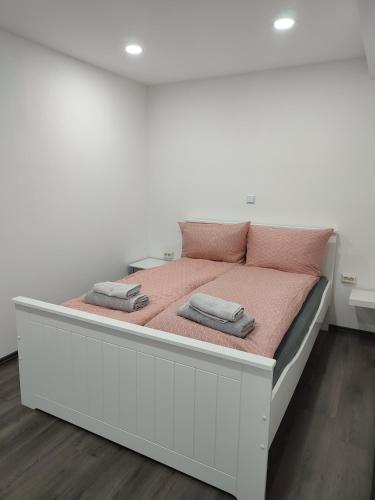 a large white bed with two pillows on it at Ferienhaus Stani in Eschwege