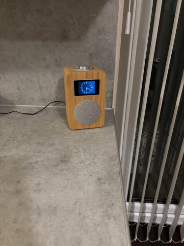 a small clock sitting on the floor next to a door at Cozy 3-bed house ideal for families and contractors with Netflix 7 miles for Birmingham City Centre in Oldbury