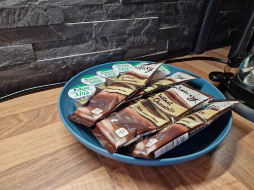 a blue plate with chocolate treats on a table at Hornscroft Park - Contemporary luxury and style in Hull