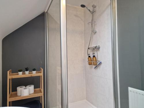 a shower with a glass door in a bathroom at Hornscroft Park - Contemporary luxury and style in Hull