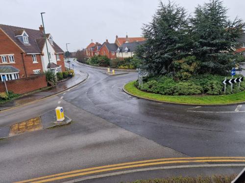 an empty street in a residential neighborhood with houses at Hornscroft Park - Contemporary luxury and style in Hull