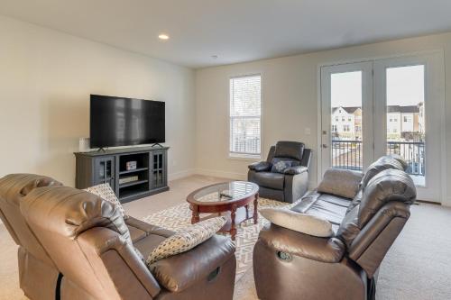 a living room with leather furniture and a flat screen tv at Balcony and Pool Access Modern Gainesville Home in Gainesville