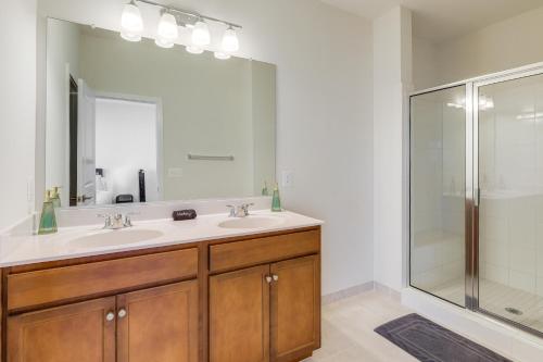 a bathroom with two sinks and a shower at Balcony and Pool Access Modern Gainesville Home in Gainesville