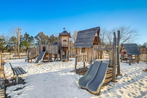 a playground in the snow with a slide at Balcony and Pool Access Modern Gainesville Home in Gainesville