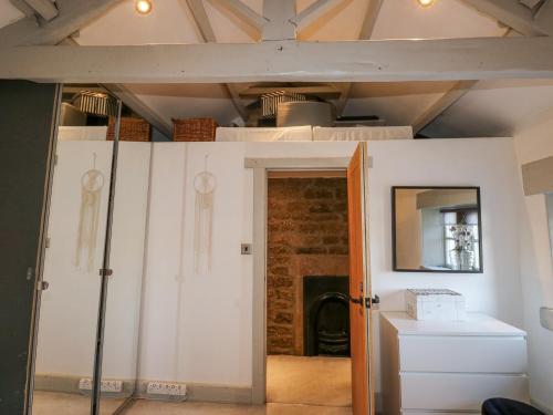 a room with white walls and a ceiling at Dreamwood Cottage in Wakefield