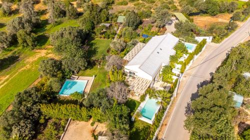 an aerial view of a house with a swimming pool at Laranjal Farm House in Moncarapacho