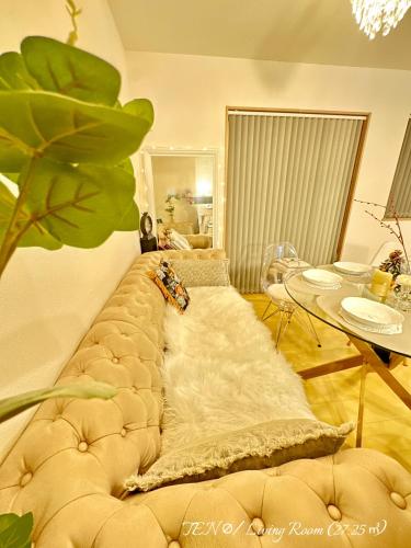 a large couch in a living room with a table at Ten10 in Nagoya