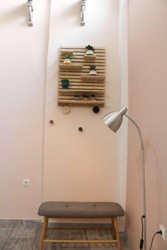 a lamp and a bench in a room at New house in Piraeus in Piraeus