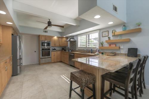 a large kitchen with a large island with bar stools at Sunshine Lagoon in Sanibel
