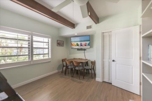 a dining room with a table and a tv at Sunshine Lagoon in Sanibel