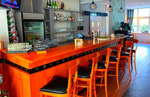 a bar with a bunch of chairs at a restaurant at Best Western Spreewald in Lübbenau
