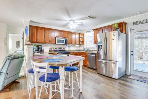 a kitchen with a table and chairs and a refrigerator at 1 Mi to Anna Maria Island Pet-Friendly Retreat in Cortez