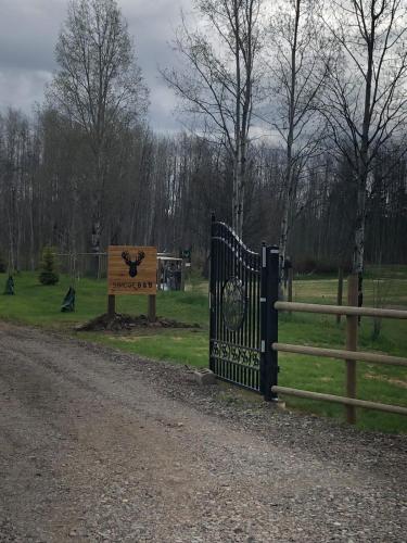 a gate at a park with a sign and a fence at Simcoe B&B - Incredible vacation suite in Smithers