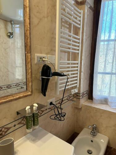 a bathroom with a sink and a mirror at L'Altro Sapore Rooms in Pitigliano