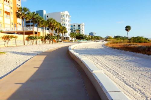 an empty street with palm trees and buildings on a beach at Boutique Beach Retreat in St Pete Beach