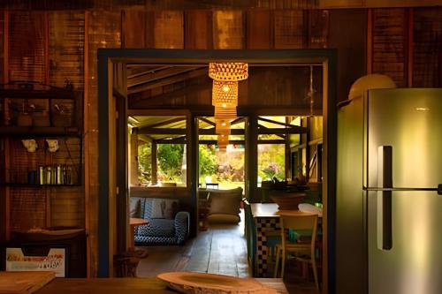 a kitchen with a refrigerator and a dining room at Lugar encantador com jacuzzi na Praia do Arandis in Marau
