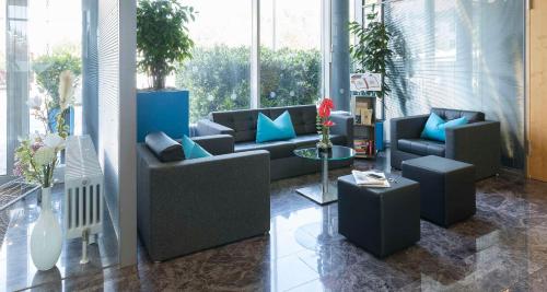 a living room with couches and chairs in a room at Best Western Hotel am Europaplatz in Königsbrunn