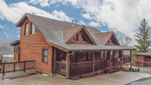 a log cabin with a gambrel roof at Moonlight Lodge Family Cabin in Pigeon Forge