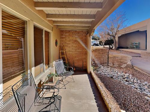 two chairs sitting on the porch of a house at Artist Road #7 in Santa Fe