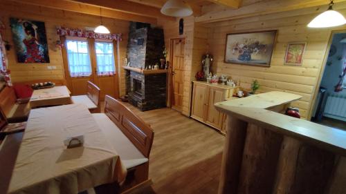 a dining room with two tables and a fireplace at Penzión u Marlenky in Spišská Stará Ves