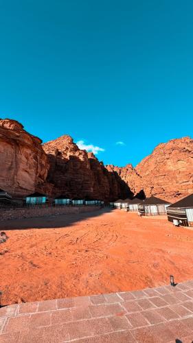 a view of a desert with mountains in the background at Mars Land Luxury Camp in Wadi Rum
