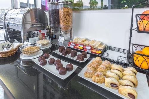 a buffet with different types of pastries on display at Atlantida Mar Hotel in Praia da Vitória