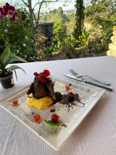 a plate of food sitting on a table at Encanto Verde cabaña sencilla in Marinilla