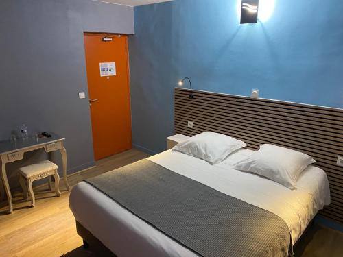 a bedroom with a large bed and a blue wall at Royal Haveli in Tergnier