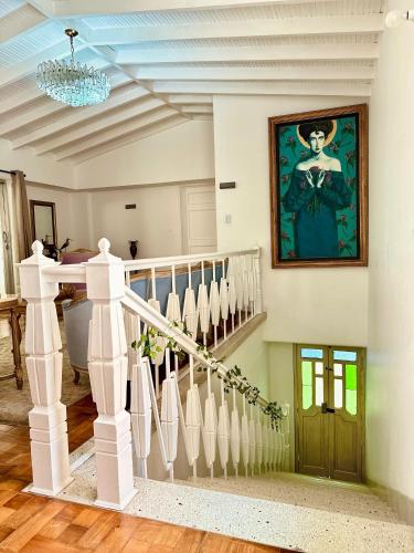 a staircase in a home with a painting on the wall at Hotel Boutique Fiorentina Medellín in Medellín
