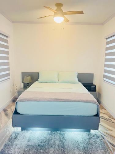 a bedroom with a bed with a ceiling fan at Maximum Beach Hotel in Corozal