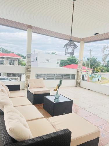a patio with couches and a pendant light at Maximum Beach Hotel in Corozal