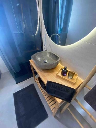 a bathroom with a sink and a large mirror at Clear Water Apartment - Seaside in Mandre