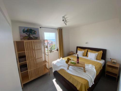 a bedroom with a large bed and a window at Clear Water Apartment - Seaside in Mandre