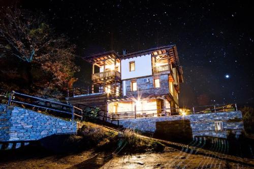 a large house is lit up at night at Панорама хаус Лещен и еко къщи Дървена и Землянка in Leshten