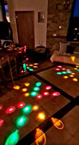 a living room with christmas lights on the floor at Панорама хаус Лещен и еко къщи Дървена и Землянка in Leshten