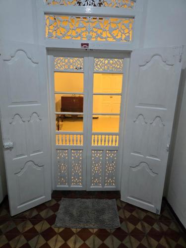 a closet with two white doors and a tile ceiling at Sudu Colonial House 1929 in Ambalangoda