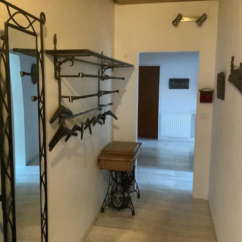 a room with a table and a shelf with shoes at Burghof Altenbüren in Brilon