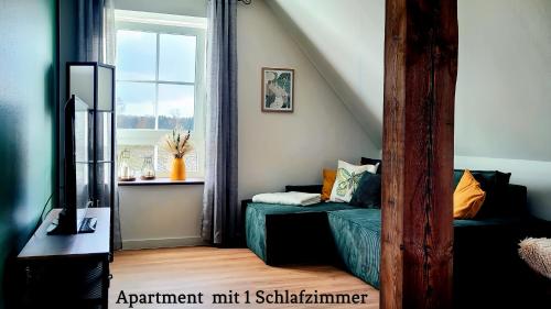 a small room with a bed and a window at Landhaus Seemann Ferienwohnungen im Grünen in Walsrode