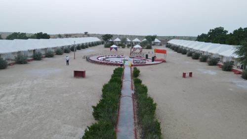 a large courtyard with umbrellas in a building at Royal Adventure Jaisalmer Resort in Jaisalmer