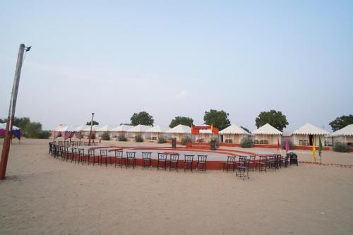 a group of tables and chairs on a beach at Royal Adventure Jaisalmer Resort in Jaisalmer