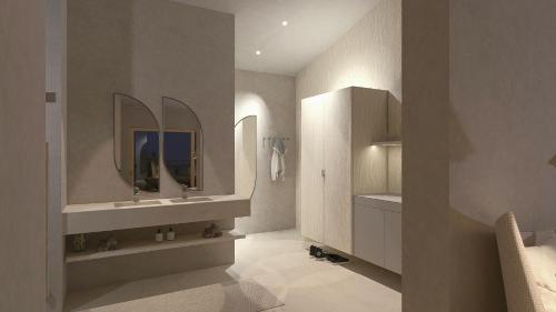 ein Badezimmer mit zwei Waschbecken und einem Spiegel in der Unterkunft ANETSEDER Landhotel & Lofts in Thyrnau