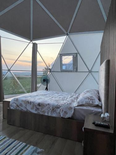 a bedroom with a large bed in a tent at Transylvania WINE in Turda