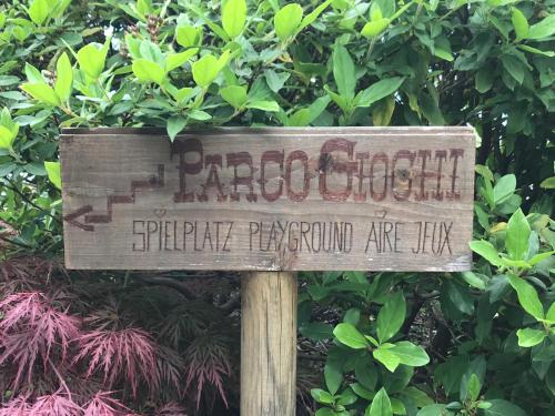 a sign in front of a bush at Hotel La Campagnola - Green Energy Resort in San Nazzaro