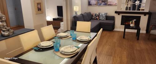a living room with a glass table and a couch at appartamento comfort Malpensa check in h 24 posto auto privato in Casorate Sempione