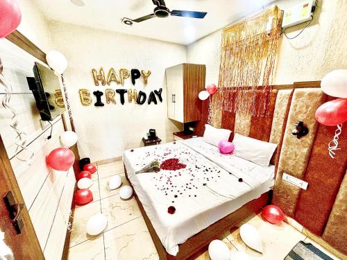 a bedroom with a happy birthday sign and balloons at BLACKWOOD -140 Metres- Near Golden Temple in Amritsar